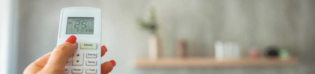 Commonly Asked Questions 3 a woman holding a remote control in her hand.