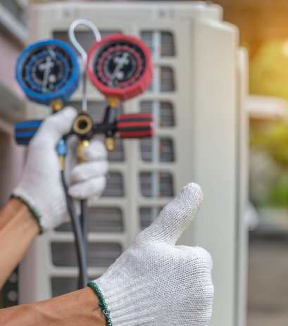 A person in white gloves holding a wrench in front of an AC unit.