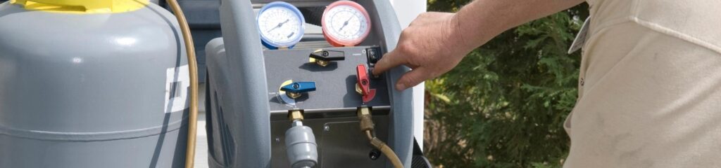 Commonly Asked Questions 2 a man holding a hose to a propane tank.